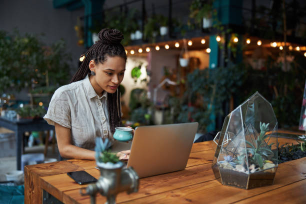 istock Concentrated young floral designer typing on her laptop 1319577381
