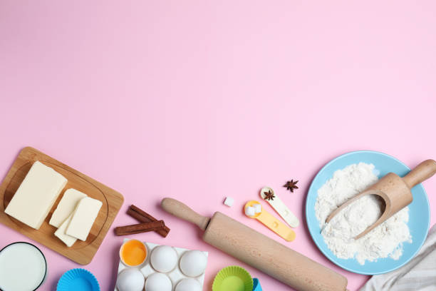 istock Cooking utensils and ingredients on pink background, flat lay. Space for text 1319578230