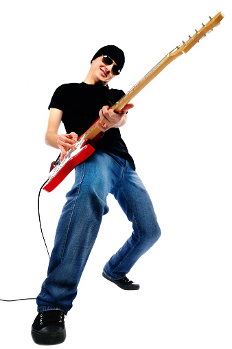 Young man plays electric guitar on back light