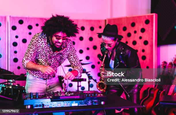 Young Happy People Playing Music With Dj Mixer And Saxophone In House Studio Youth Musician Enterteinment Concept Stock Photo - Download Image Now