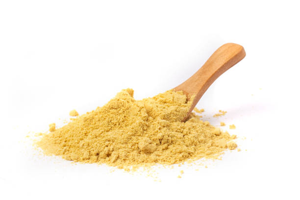 istock Powder mustard with wooden spoon isolated on a white background. 1319581780