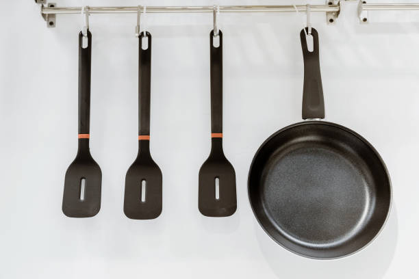 istock Close-up of kitchen utensils hanging on hooks 1319581945