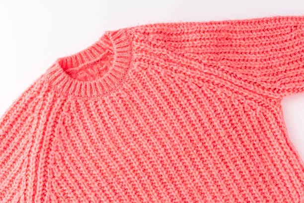 istock Pink knitted sweater isolated on white background. Flat lay. Top view 1319581956