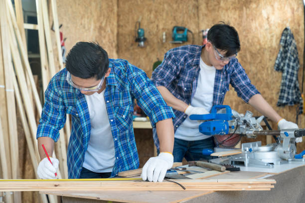istock Craftsmans working together at carpentry shop. Worker or Professional constructor repair in wood working. 1319584857