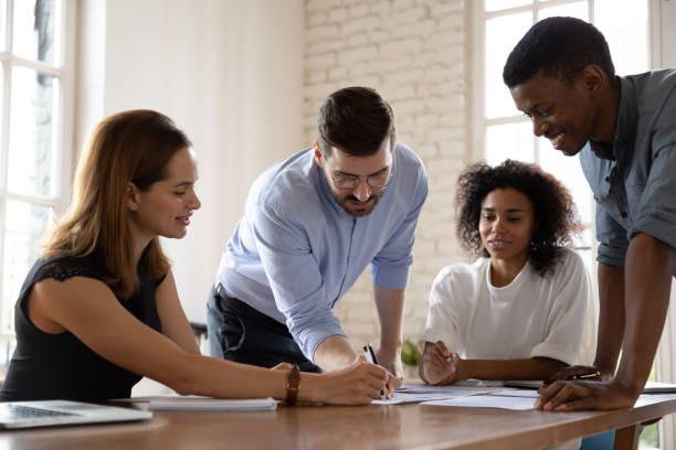 istock Happy millennial multiracial business people discussing project development strategy. 1319587096