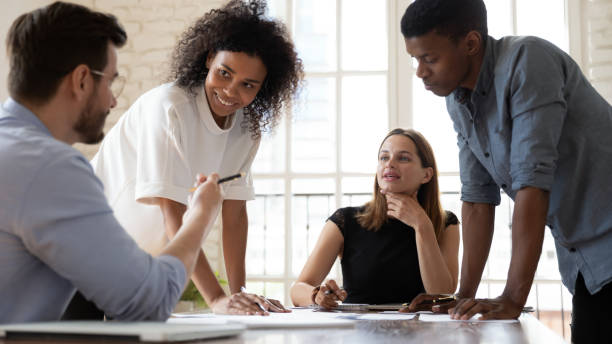 istock Happy multiracial colleagues discussing project strategy in office. 1319587098