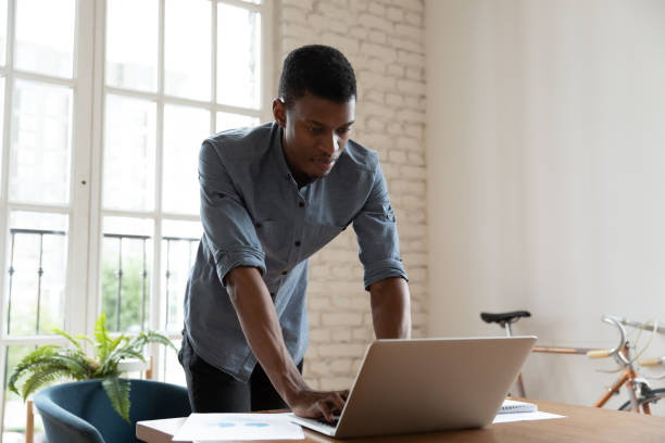 istock Concentrated young african american businessman working on computer. 1319587129