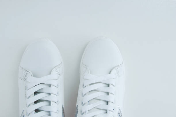 istock White sneakers with laces on white background. View from above. 1319587592