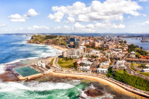 D Newcastle pool CBD Panorama of Newcastle city on the hills over Hunter river and Pacific ocean with beaches, pool and surfers. newcastle new south wales photos stock pictures, royalty-free photos & images