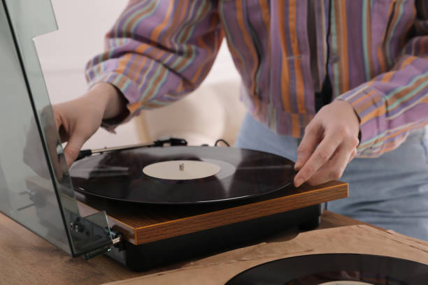 istock Young woman using turntable at home, closeup 1319588844