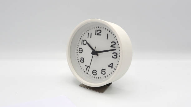 istock Modern and clean white color clock with minute hand and hour hand on white background and isolated studio shot. 1319588926