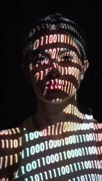Binary digits on a woman's face.