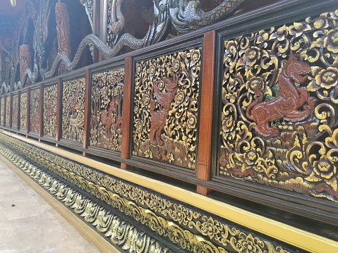 Beautiful wooden carvings at buddhist temple in Thailand.