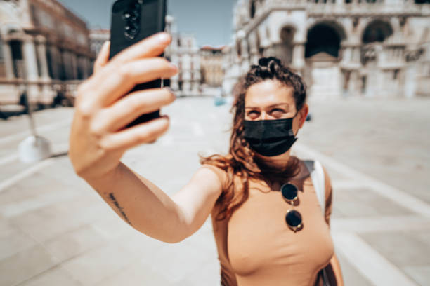 istock tourist in venice wearing a face mask 1319592627