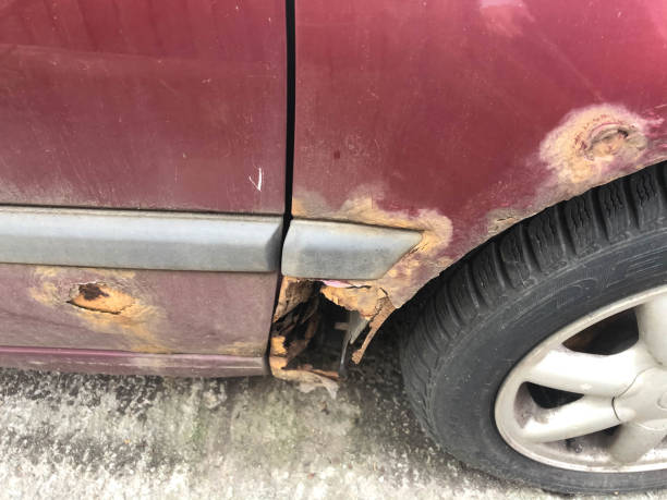 istock Rusty car close up with a hole in the old car. 1319592738