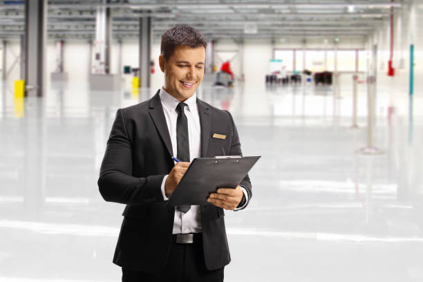 istock Airport male attendant writing a document inside a terminal building 1319593353