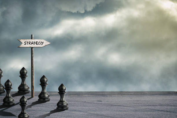 Strategy concept. Wooden pointer. Black pawns. Cloudy sky. Business. Leadership. Correct strategy Abstract background Background