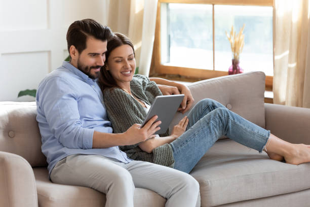 istock Happy couple relax at home using tablet 1319593771
