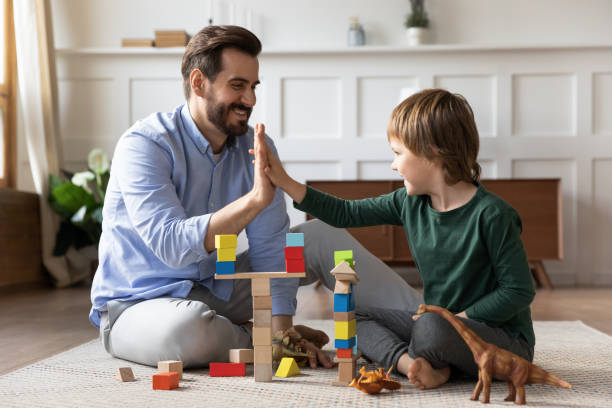 istock Happy dad and little son give high five playing 1319593774