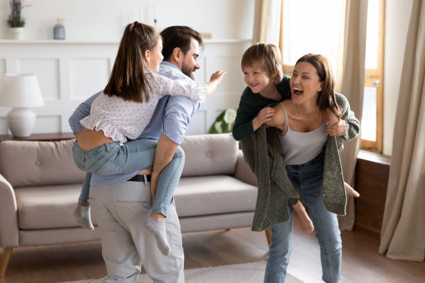 istock Excited little kids play with young parents 1319593801