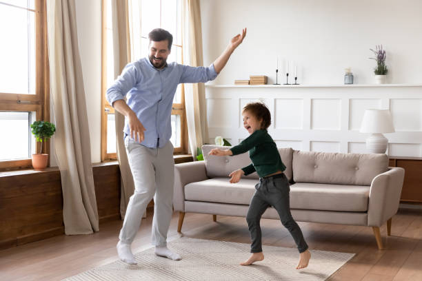 istock Happy young father and little son dancing at home 1319593804