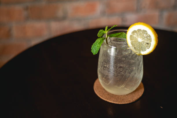 istock Lemon soda. Beverage for summer with brick wall background. 1319593998