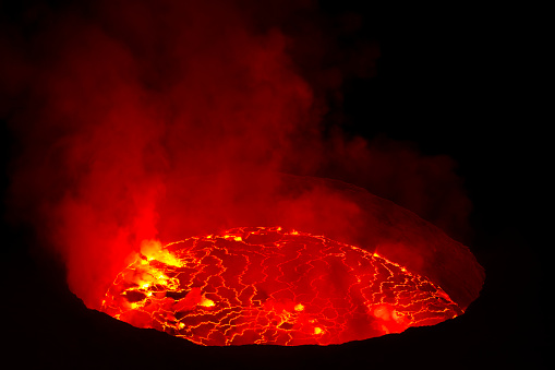 View into the lava lake inside the crater of Nyiragongo volcano – this is the largest lava lake on earth. \n\nThe 3470 m high volcano Nyiragongo belongs to the group of Virunga volcanoes in the border triangle of DR Congo, Uganda and Rwanda and is one of the most dangerous volcanoes on earth. The nearby city of Goma (the capital of the Congolese province of North Kivu) is constantly threatened by the nearby volcano.