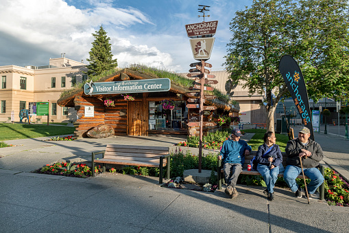Anchorage, AK, USA - June 4, 2019- Locals pose for photo on park bench near the visitor center  in Anchorage Alaska.