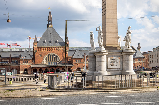 Monument to celebrate the removal of serfdom in Denmark in 1848 called Frihedsstøtten - freedom monument. In the background there is a view to the central railway station in Copenhagen