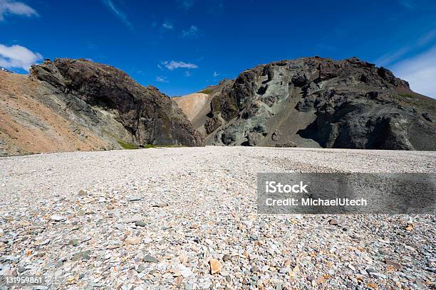 Pebble Stone Field In Front Of Volcanic Mountains Stock Photo - Download Image Now - Blue, Canyon, Clear Sky