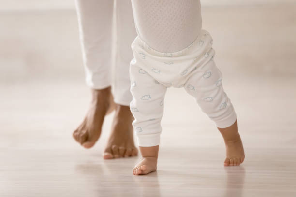 istock Close up of small toddler baby learn walking 1319599197