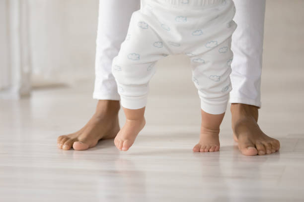 primo piano del piccolo bambino fanno i primi passi - steps baby standing walking foto e immagini stock