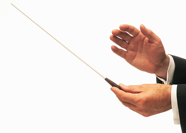 Two hands of a male music conductor holding a baton stock photo