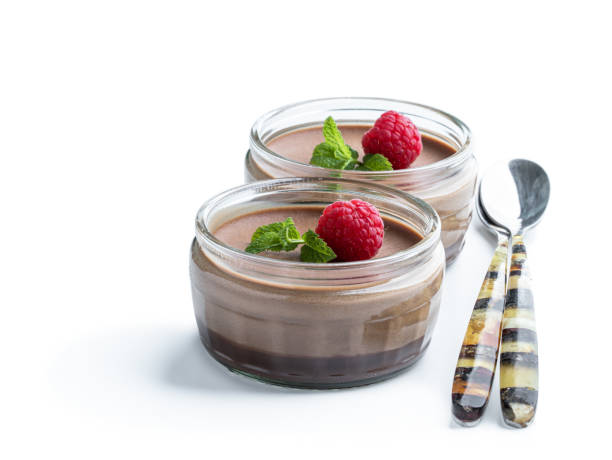 istock Mini caramel cheesecakes with raspberry in a glass pots isolated on white background 1319602708