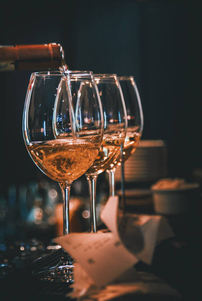 istock bartender pouring white wine into a glass in cafe or bar 1319602709