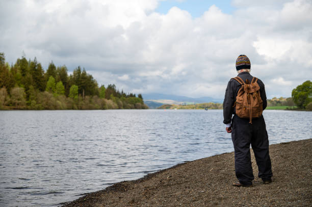 istock Rear view of an active mature man at a loch 1319603653