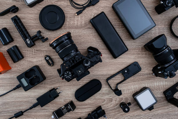 istock top view of work space photographer with digital camera, flash, cleaning kit, memory card, tripod and camera accessory on black table background 1319604103