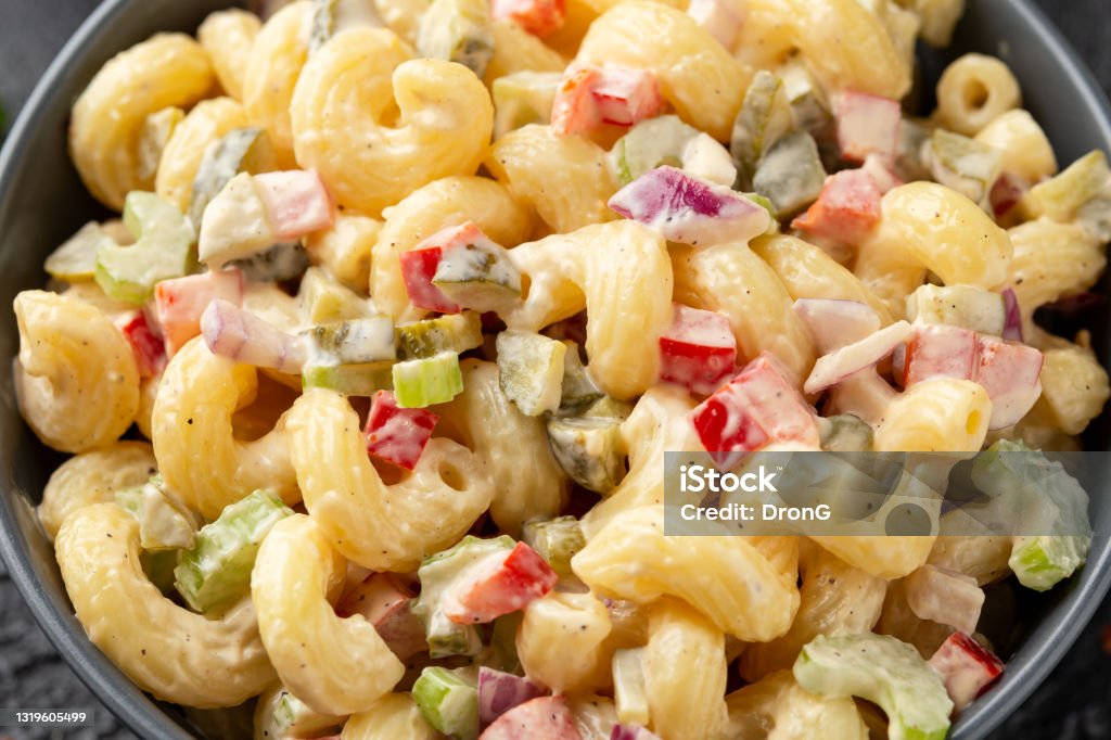 Macaroni Salad with red bell pepper, onion, celery, gherkins and mayonnaise dressing Macaroni Salad with red bell pepper, onion, celery, gherkins and mayonnaise dressing. Macaroni Stock Photo