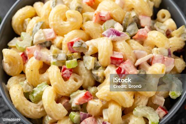 Macaroni Salad With Red Bell Pepper Onion Celery Gherkins And Mayonnaise Dressing Stock Photo - Download Image Now