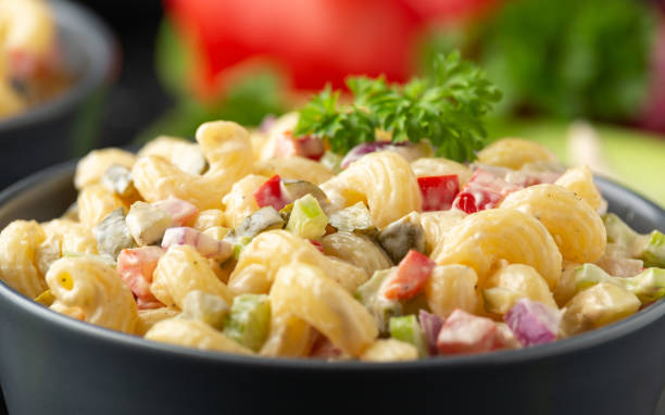 istock Macaroni Salad with red bell pepper, onion, celery, gherkins and mayonnaise dressing 1319605548