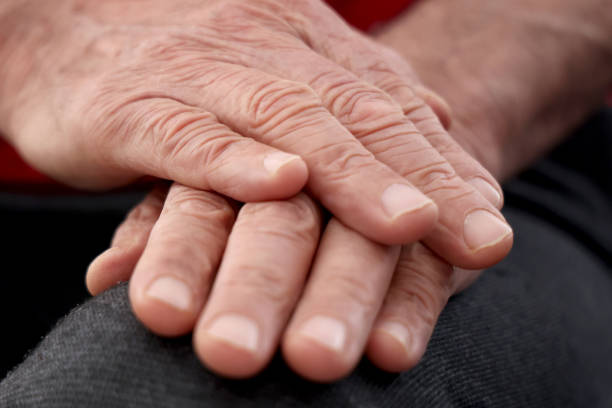 close up of senior man - human hand old senior adult aging process stock-fotos und bilder