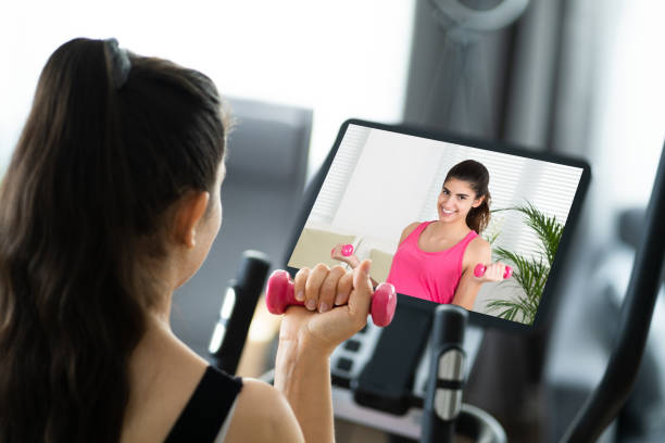 istock Woman Training With Dumbbells Online 1319610986