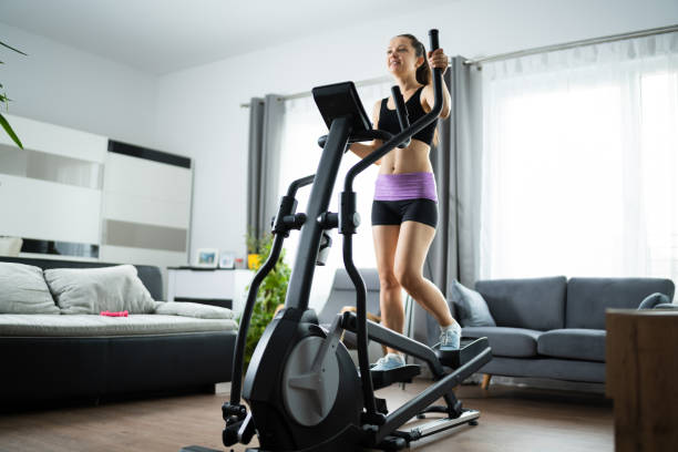 istock Woman Training On Elliptical Trainer 1319611019