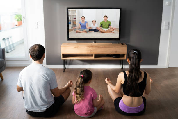 istock Family Doing Yoga Meditation Online Class 1319611049