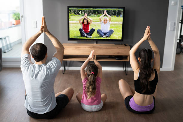 istock Family Doing Yoga Meditation Online Class 1319611055