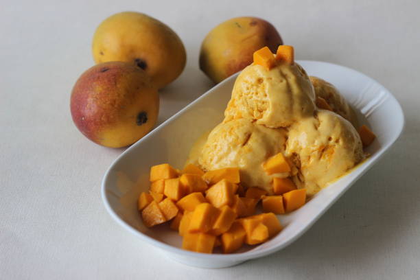 istock Scoops of Home made mango ice cream served with fresh cut Lalbagh mangoes. 1319611250