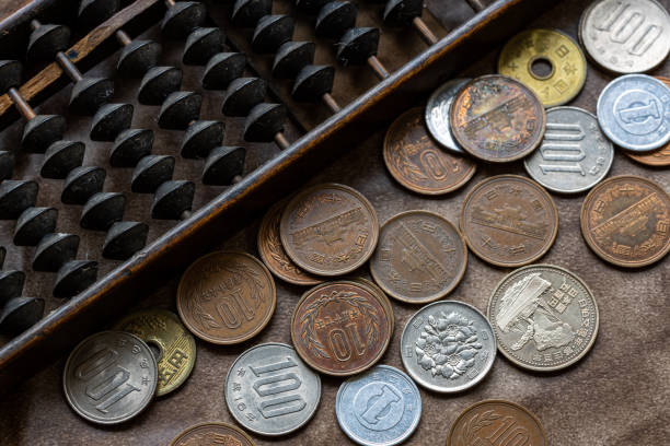 istock Japanese abacus and coins 1319612161