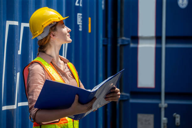 Containers woman worker using Folders file to inspection Containers box . female foreman Check inventory by Documents at warehouse logistic in Cargo freight ship for import export. shipping contenedores mujer trabajadora utilizando el archivo de carpetas para inspeccionar contenedores caja . capataz femenina verificar inventario por documentos en logística de almacén en buque de carga para exportación de importación. naviero