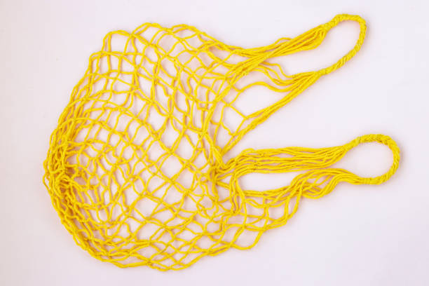 istock Empty reusable shopping yellow mesh bag on white background, horizontal orientation, Zero waste concept, copy space 1319615377