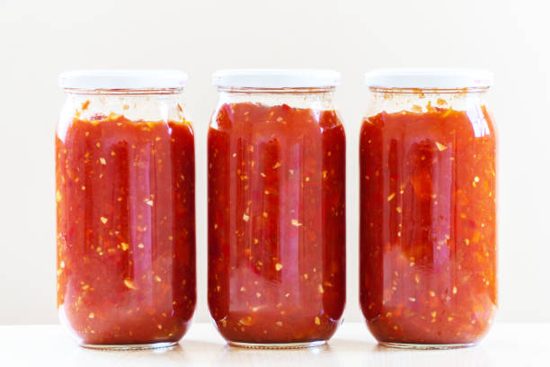 istock Tomato sauce in glass jars 1319616603